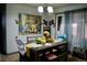 Dining area featuring a rectangular table with bench seating, complemented by an artwork and bright lighting at 1375 N Iola St, Aurora, CO 80010