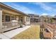 Landscaped backyard featuring a covered patio with space for outdoor dining at 7884 Blue River Ave, Littleton, CO 80125