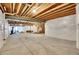 Spacious unfinished basement with exposed ceiling rafters and steel support beams at 7884 Blue River Ave, Littleton, CO 80125