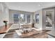 Sunlit dining area with wood floors, views to the outside and seating for four at 7884 Blue River Ave, Littleton, CO 80125