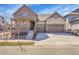 Charming two-story home features a welcoming front porch and a two-car garage at 7884 Blue River Ave, Littleton, CO 80125