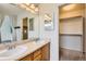 Bathroom featuring a double vanity, a mirror, a walk-in closet and a shower at 12507 Dexter Way, Thornton, CO 80241