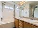 Bright bathroom with double sinks, lots of light, and a tub/shower combo at 12507 Dexter Way, Thornton, CO 80241