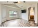 Bright bedroom with large window, wood floors, and an ensuite bathroom at 12507 Dexter Way, Thornton, CO 80241