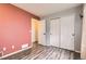 Bedroom with trendy colored walls, wood floors, and closet at 12507 Dexter Way, Thornton, CO 80241