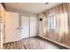 This bedroom features a sliding door closet, hardwood floors, and natural light from a window at 12507 Dexter Way, Thornton, CO 80241