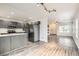 Modern kitchen featuring stainless steel appliances, gray cabinetry, and an island at 12507 Dexter Way, Thornton, CO 80241