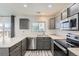 Kitchen features stainless steel appliances, ample counter space, and gray cabinetry at 12507 Dexter Way, Thornton, CO 80241