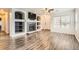 Modern living room featuring a fireplace, wood-look floors and natural light at 12507 Dexter Way, Thornton, CO 80241