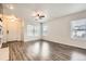 Bright living room features wood-look floors and plenty of natural light at 12507 Dexter Way, Thornton, CO 80241