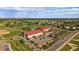 Aerial view showcases large buildings, parking lots, roads with cars, a pond, trees and buildings in the background at 10321 W 59Th Ave # 2, Arvada, CO 80004