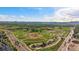 Capture the scenic beauty with this aerial view of baseball fields, picturesque landscapes, and mountains in the distance at 10321 W 59Th Ave # 2, Arvada, CO 80004