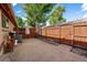 Private backyard with a concrete patio, shaded by mature trees, enclosed by a wood fence at 10321 W 59Th Ave # 2, Arvada, CO 80004
