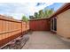 Enclosed backyard featuring a concrete patio, a wooden shed, and a privacy fence, perfect for outdoor enjoyment at 10321 W 59Th Ave # 2, Arvada, CO 80004