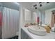 Stylish bathroom with a modern sink, sleek vanity, and a shower with a white curtain at 10321 W 59Th Ave # 2, Arvada, CO 80004