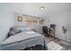 Cozy bedroom featuring wood floors, a window for natural light, and a dedicated workspace for convenience at 10321 W 59Th Ave # 2, Arvada, CO 80004