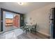 Cozy dining area with a white table, green chairs, and sliding door to the outdoor area at 10321 W 59Th Ave # 2, Arvada, CO 80004