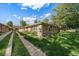Well-maintained brick exterior of a multi-unit dwelling with a tidy lawn and walkway at 10321 W 59Th Ave # 2, Arvada, CO 80004