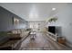 Inviting living room with comfortable seating, a large TV, and plenty of natural light at 10321 W 59Th Ave # 2, Arvada, CO 80004