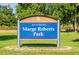 Welcome to Marge Roberts Park sign surrounded by well-maintained greenery creating a serene and inviting atmosphere at 10321 W 59Th Ave # 2, Arvada, CO 80004