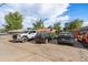 Spacious parking area displaying multiple vehicles under a bright, cloudy sky at 10321 W 59Th Ave # 2, Arvada, CO 80004