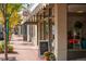 Charming street view of local stores with sidewalk signage and potted plants, showcasing local shops and eateries at 10321 W 59Th Ave # 2, Arvada, CO 80004