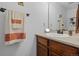 Bathroom sink with wooden vanity, white countertop, and decorative towels on a rack at 4020 E 94Th Ave # B, Thornton, CO 80229