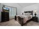 Bedroom with a large dark wood bed, matching nightstands, and a TV on a dresser at 4020 E 94Th Ave # B, Thornton, CO 80229