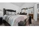 Bedroom with a large bed, dresser with mirror and doorway to the bathroom at 4020 E 94Th Ave # B, Thornton, CO 80229