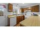 Functional kitchen with wood cabinets and bright lighting, adjacent to dining area at 4020 E 94Th Ave # B, Thornton, CO 80229