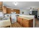 Well-equipped kitchen with wood cabinets, white appliances, and a practical layout at 4020 E 94Th Ave # B, Thornton, CO 80229