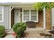 Inviting covered porch with brick accents and a cozy bench, perfect for relaxing outdoors at 4020 E 94Th Ave # B, Thornton, CO 80229