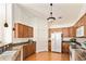 Spacious kitchen with wood cabinets, granite countertops, and modern appliances at 8645 Gold Peak Pl # A, Highlands Ranch, CO 80130