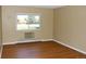 Bright bedroom featuring hardwood floors and large window with natural light at 14390 E Marina Dr # 204, Aurora, CO 80014