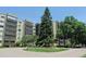 Multi-story condo building featuring balconies, mature trees, and landscaping creating a serene environment at 14390 E Marina Dr # 204, Aurora, CO 80014