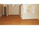 Open living room with wood floors connected to doorway and window to the bright kitchen at 14390 E Marina Dr # 204, Aurora, CO 80014
