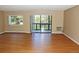 Bright living room featuring wood floors, large window, and sliding glass door to a private balcony at 14390 E Marina Dr # 204, Aurora, CO 80014