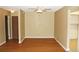 Living room with wood floors connected to doorways and window to kitchen at 14390 E Marina Dr # 204, Aurora, CO 80014
