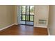 Living room with hardwood floors and sliding glass doors leading to a balcony at 14390 E Marina Dr # 204, Aurora, CO 80014