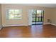 Bright living room featuring wood floors, large window, and sliding glass door to a private balcony at 14390 E Marina Dr # 204, Aurora, CO 80014