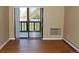 Living room with hardwood floors and sliding glass doors leading to a balcony at 14390 E Marina Dr # 204, Aurora, CO 80014