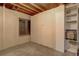 Unfinished basement area with storage shelves and a window for natural light at 18605 E Saratoga Pl, Aurora, CO 80015