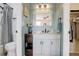 Bathroom with a white vanity, granite countertop, framed mirror and bathtub with shower at 18605 E Saratoga Pl, Aurora, CO 80015