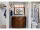 Bathroom with a wooden vanity, a framed mirror and a bathtub with shower at 18605 E Saratoga Pl, Aurora, CO 80015