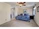 Cozy bedroom featuring a ceiling fan, a connecting bathroom and a plush carpet at 18605 E Saratoga Pl, Aurora, CO 80015