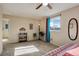 Bright bedroom with a ceiling fan, plush carpet, and a window with neighborhood views at 18605 E Saratoga Pl, Aurora, CO 80015