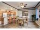 Cozy dining area featuring a glass table, comfortable chairs, and adjacent kitchen with breakfast bar seating at 18605 E Saratoga Pl, Aurora, CO 80015