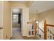 Upstairs hallway with a view into a bedroom featuring natural light and neutral decor at 18605 E Saratoga Pl, Aurora, CO 80015