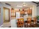 Kitchen with breakfast bar, wood cabinets, tile backsplash, and stainless steel appliances at 18605 E Saratoga Pl, Aurora, CO 80015