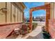 Inviting porch with brick archway and cozy seating area to enjoy the beautiful day at 18605 E Saratoga Pl, Aurora, CO 80015